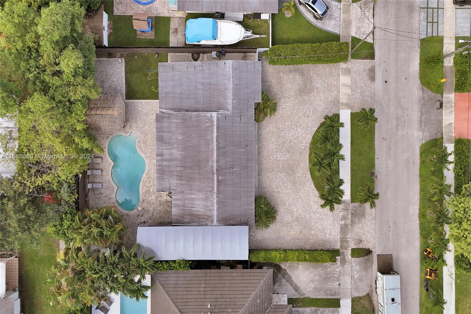 An aerial view shows a house with a pool, a paved driveway, and a boat — 1910 N Hibiscus Dr, North Miami FL 33181, NORTH MIAMI, FL
