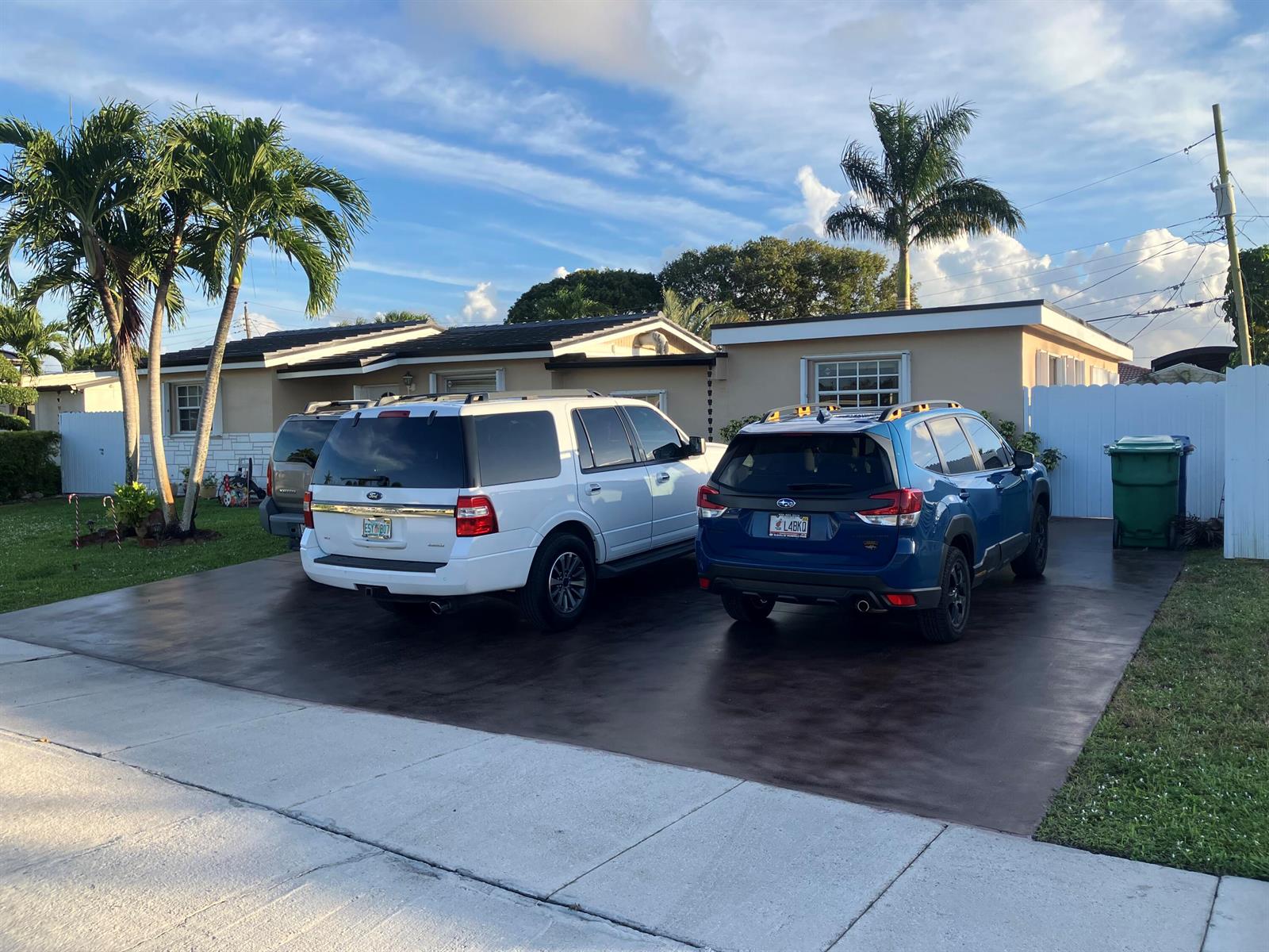 A single-story house with a driveway featuring a white SUV and a blue SUV — 7960 NW 174th Street, Hialeah FL 33015, HIALEAH, FL