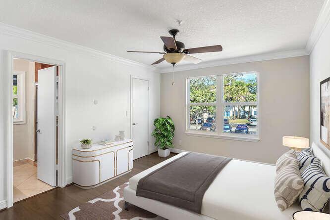 A bedroom features a ceiling fan, a white dresser, a bed, and a bathroom doorway — 2311 N Congress Avenue # 28, Boynton Beach FL 33426, BOYNTON BEACH, FL