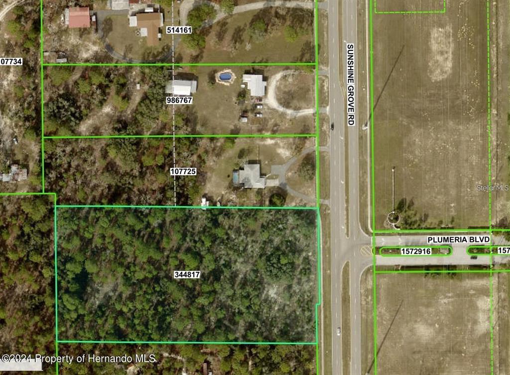 This is an aerial map showing property boundaries and parcel numbers along a road — SUNSHINE GROVE ROAD, BROOKSVILLE, FL
