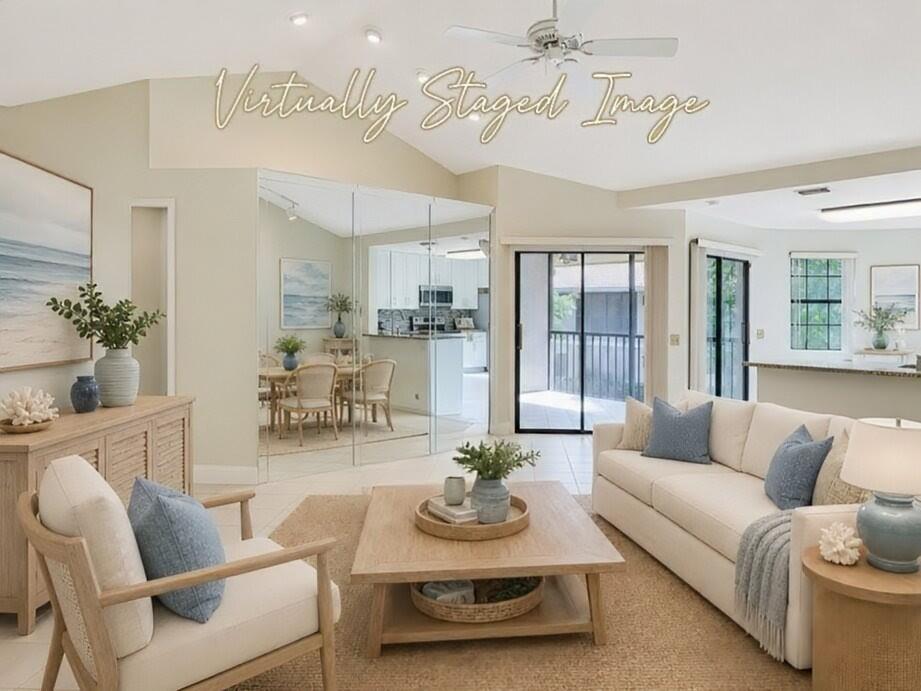 This virtually staged living room features a vaulted ceiling, mirrored wall, and neutral coastal decor — 6698 Montego Bay Boulevard # D, Boca Raton FL 33433, BOCA RATON, FL