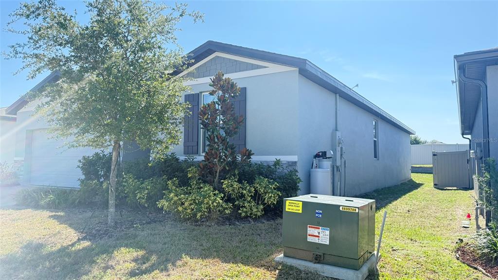A single-story house with a gray exterior, a two-car garage, and a paved driveway — 2618 IRISH ELK AVENUE, DAVENPORT, FL