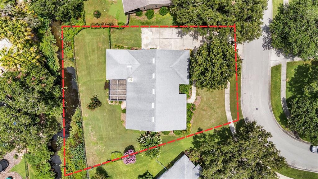 An aerial view shows a house with a gray roof and a screened-in porch — 549 PENINSULAR DRIVE, LAKELAND, FL