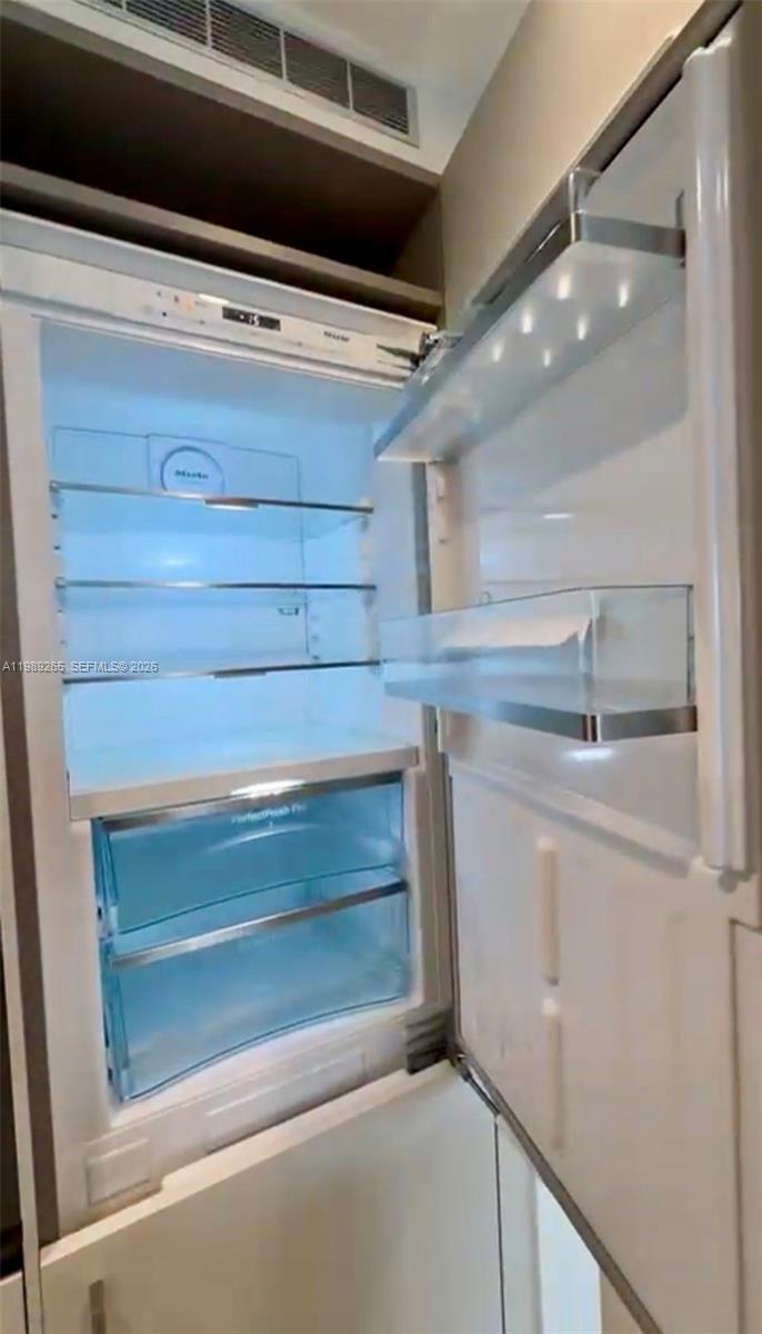 An open, empty white refrigerator with glass shelves and two bottom drawers — 1000 brickell plz # 2008, Miami FL 33131, MIAMI, FL