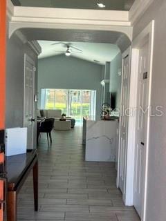 A view through an arched entryway into a living area with tile flooring and furniture — 442 VIZCAY WAY, DAVENPORT, FL