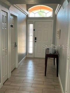 A tiled entryway leads to a white front door with a transom window above — 442 VIZCAY WAY, DAVENPORT, FL