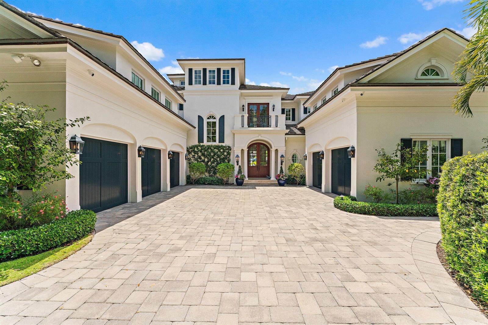 A large, two-story house with a paved motor court and multiple dark garage doors — 103 Quayside Drive, Jupiter FL 33477, JUPITER, FL