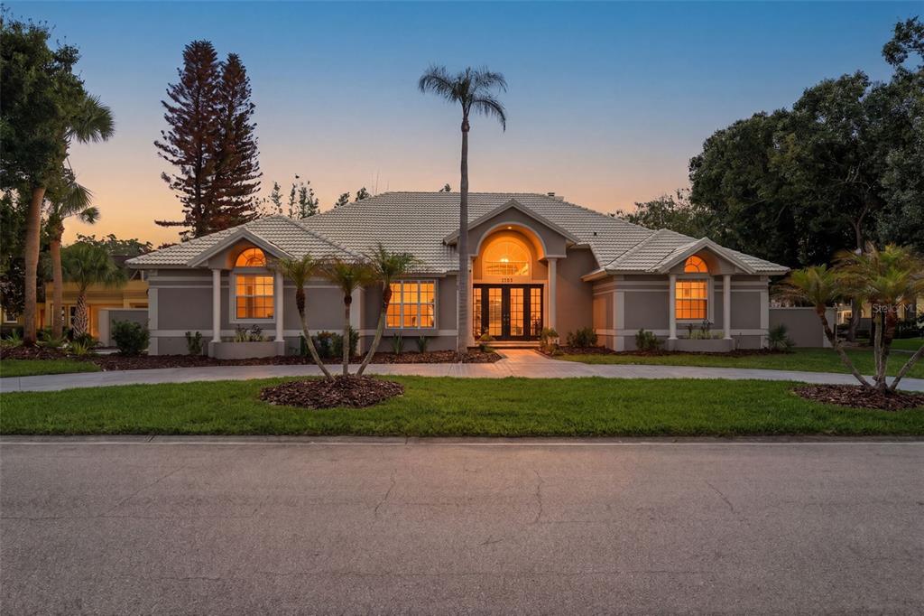 A single-story house with a tiled roof, arched windows, and a central arched entryway — 8935 JONATHAN MANOR DRIVE, ORLANDO, FL