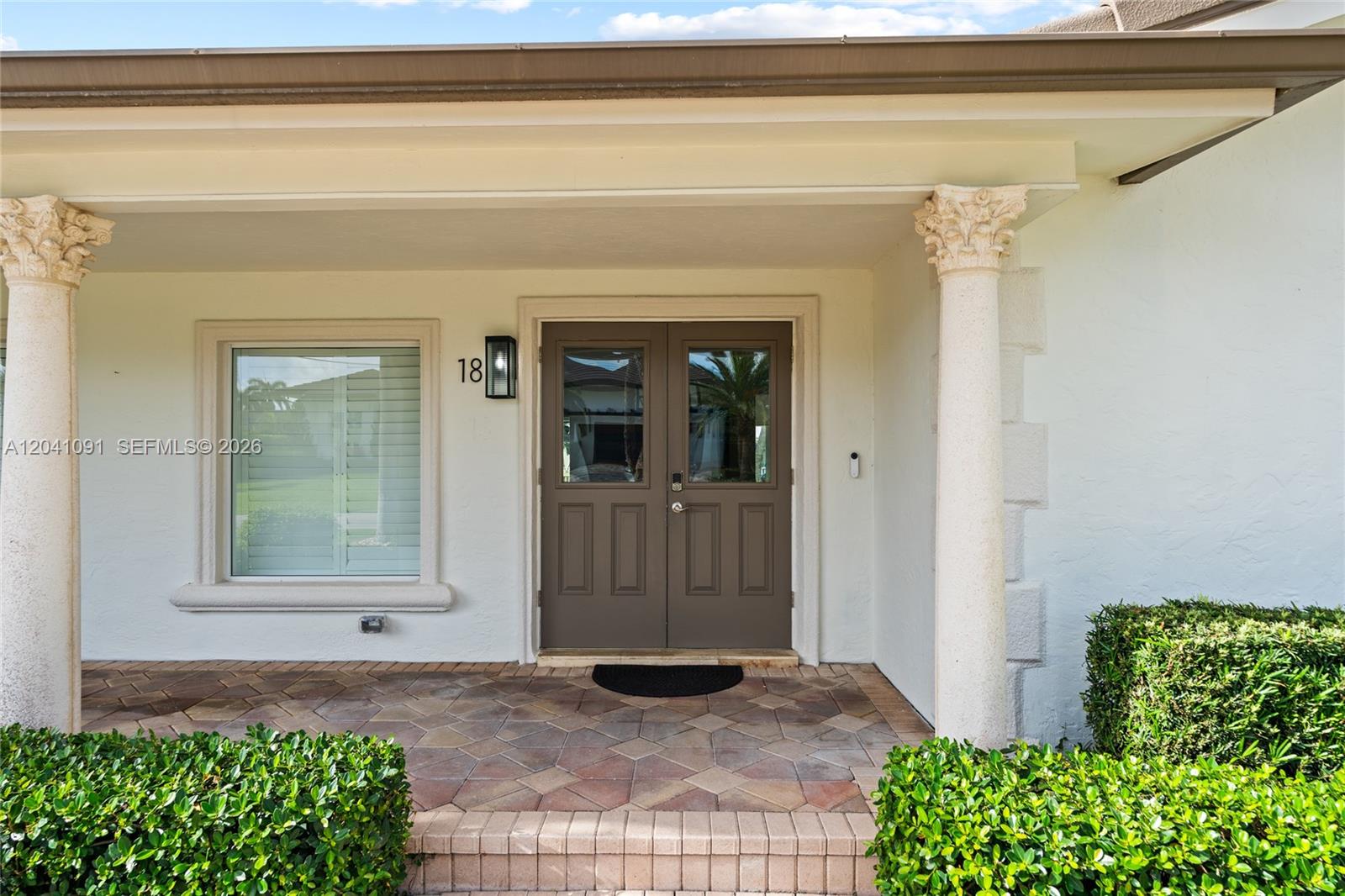 A front entryway features a double door, two columns, and a tiled porch — 18 Eleuthera Dr, Ocean Ridge FL 33435, OCEAN RIDGE, FL