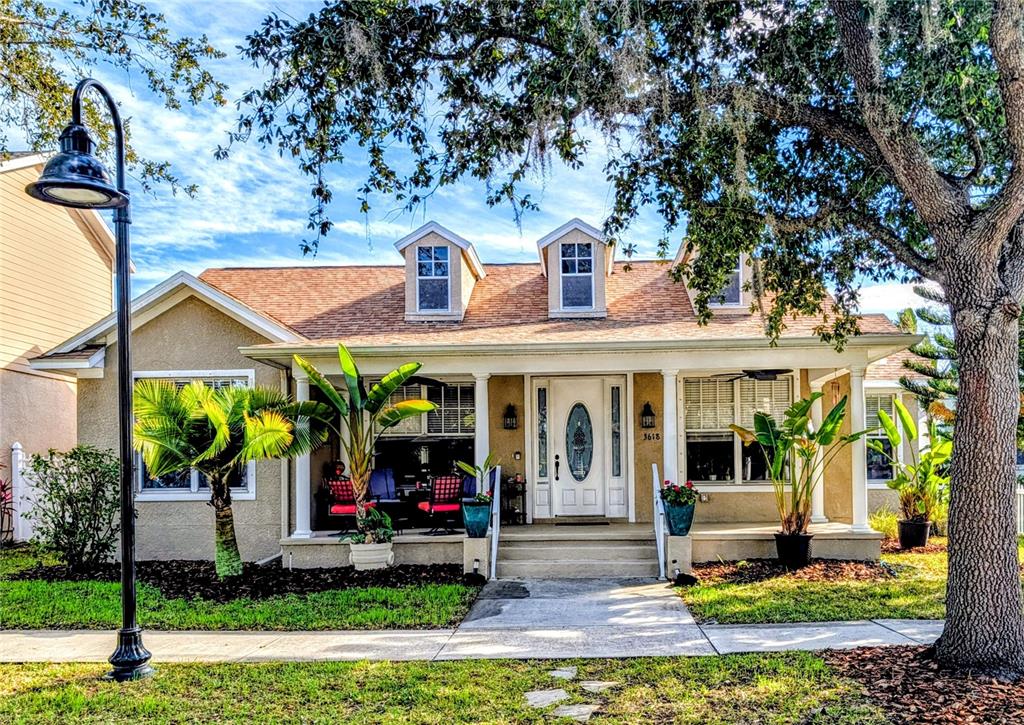 A single-story house with a front porch, three dormer windows, and a large shade tree — 3618 BUFFETT STREET, NEW PORT RICHEY, FL