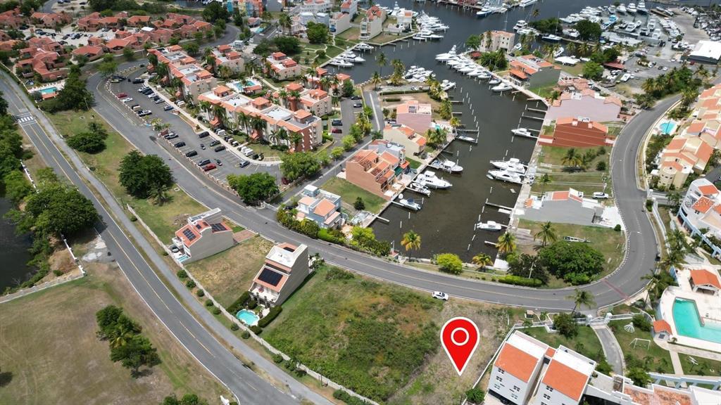 An aerial view shows a vacant lot marked with a pin near a residential marina — HARBOUR DRIVE DR. #13 E PALMAS DEL MAR, HUMACAO, PR