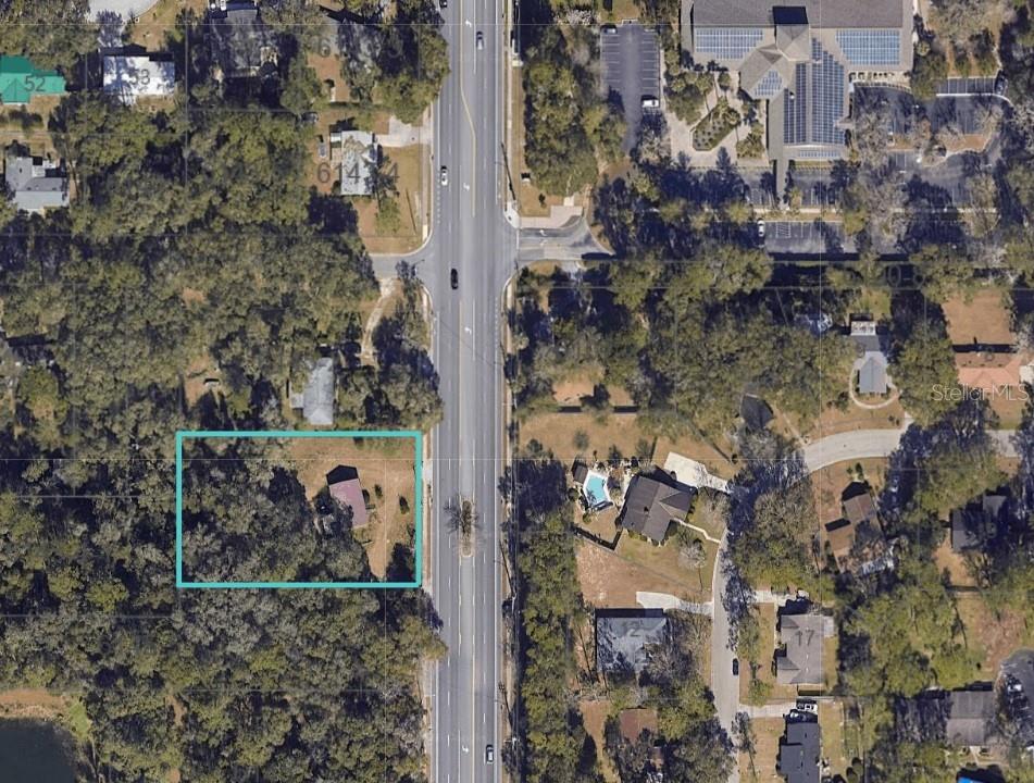 An aerial map view shows a rectangular property lot outlined in teal along a road — 3002 NW 43RD STREET, GAINESVILLE, FL
