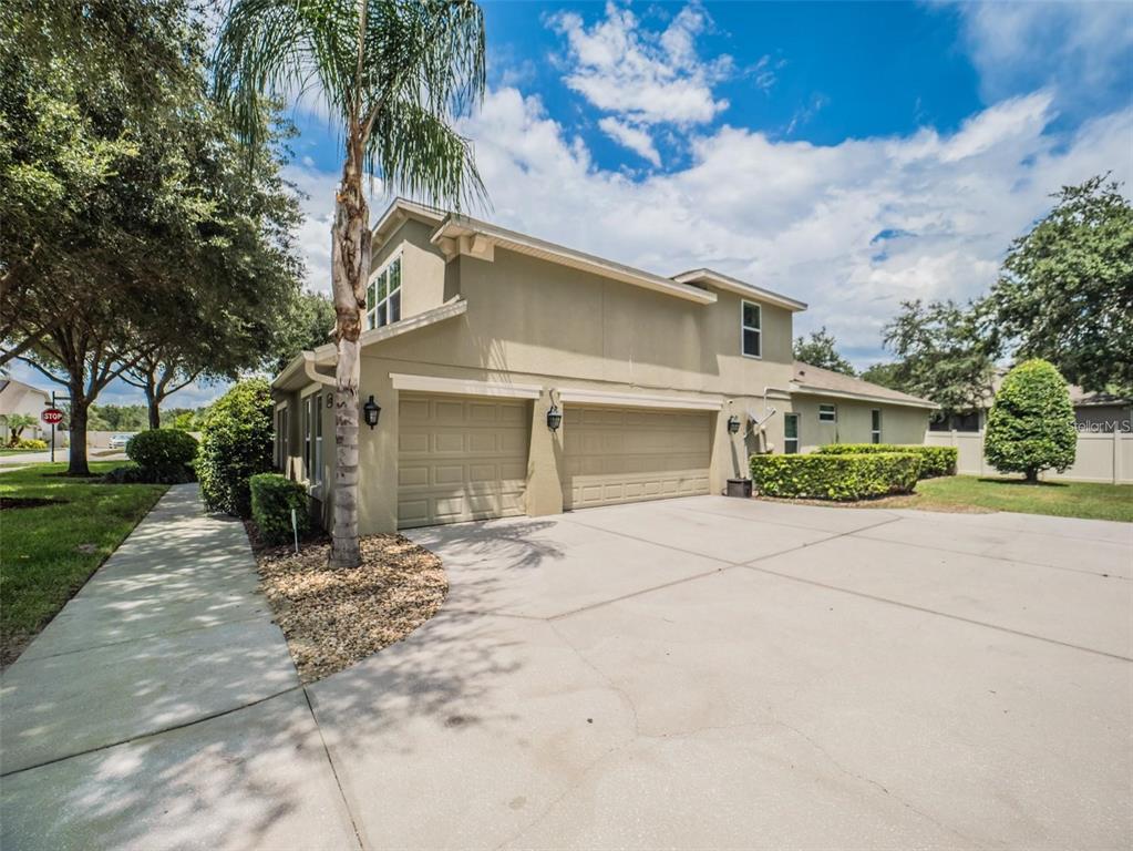 A two-story house with a beige exterior, a three-car garage, and a concrete driveway — 4443 PINE GOLD AVENUE, APOPKA, FL