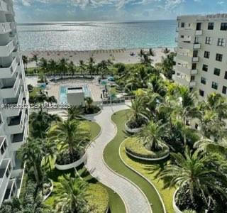 An elevated view of a coastal resort featuring a swimming pool, landscaped gardens, and beach — 100 Lincoln Rd # 323, Miami Beach FL 33139, MIAMI BEACH, FL
