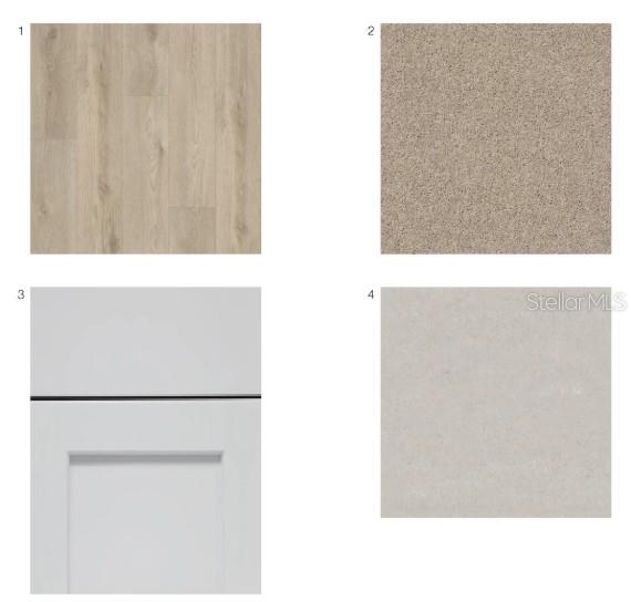 A modern kitchen with gray cabinets and a white island opens to a living area — 7162 GRAND FOREST WAY, NOKOMIS, FL