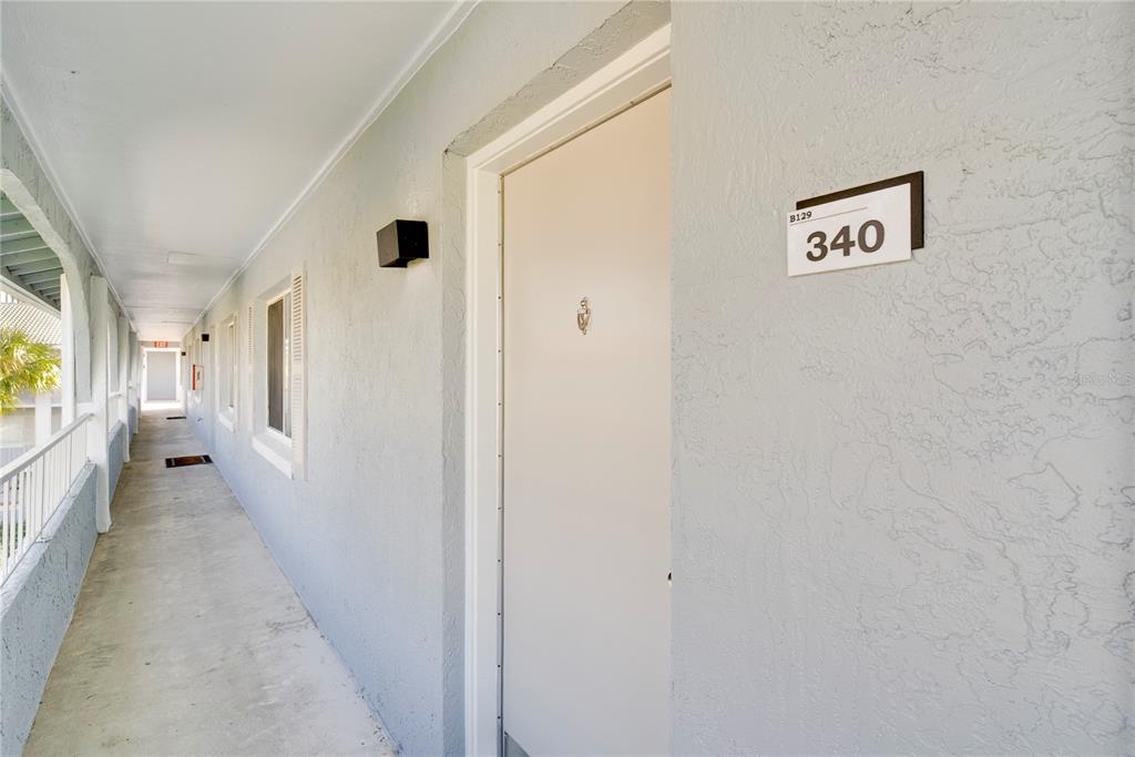 An exterior walkway leads to a beige apartment door marked with the number 340 — 129 BLUE POINT WAY UNIT 340, ALTAMONTE SPRINGS, FL