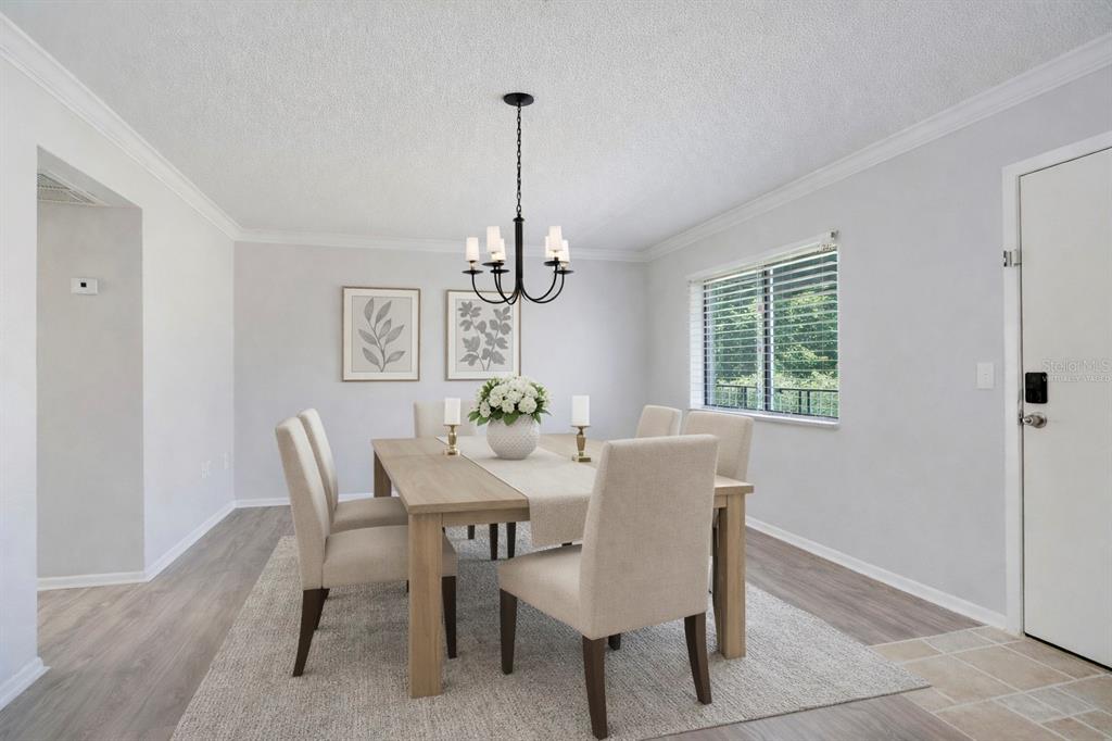 A dining room features a wooden table, six upholstered chairs, a chandelier, and light flooring — 129 BLUE POINT WAY UNIT 340, ALTAMONTE SPRINGS, FL