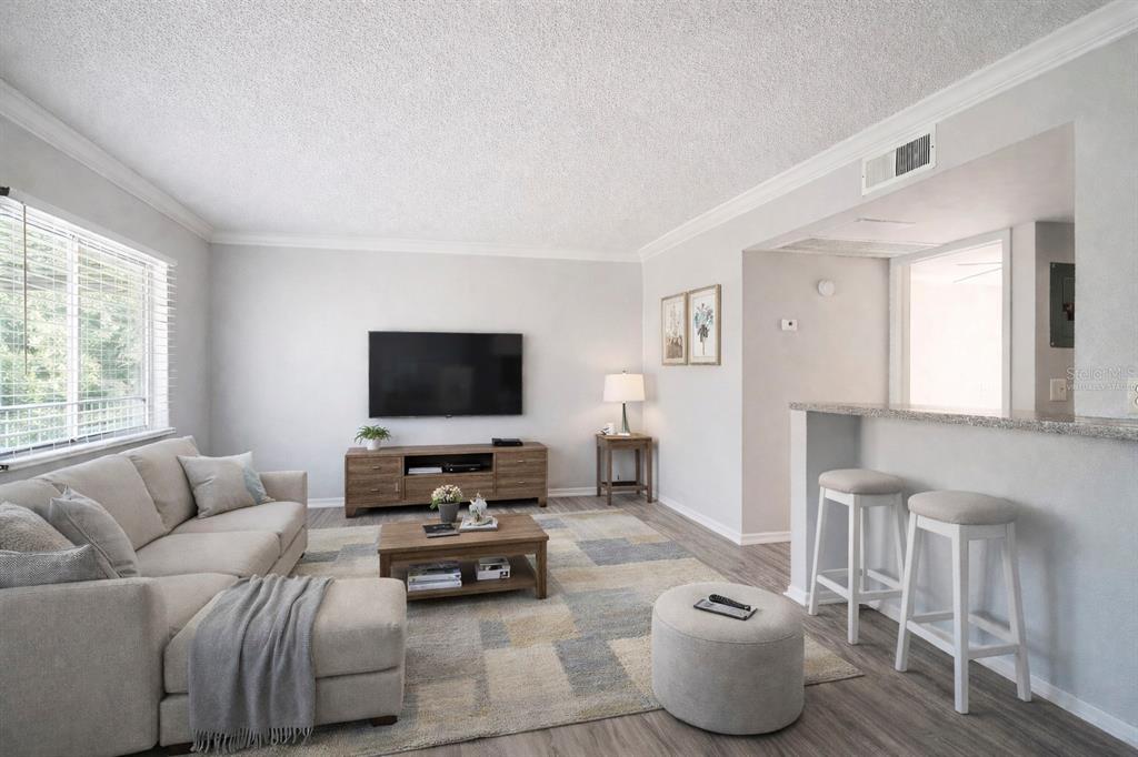 A living room features a sectional sofa, television, coffee table, and a breakfast bar area — 129 BLUE POINT WAY UNIT 340, ALTAMONTE SPRINGS, FL