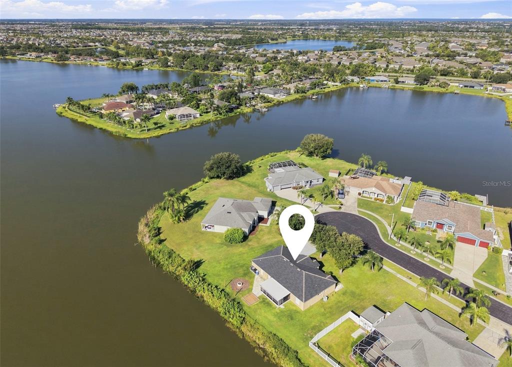 An aerial view shows a house on a waterfront lot with a cul-de-sac street — 6505 CLAIR NEST COURT, APOLLO BEACH, FL