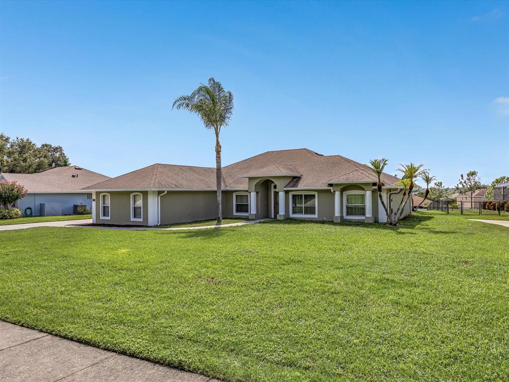 An aerial view shows a single-family home with a large yard outlined in red — 11519 GRAND BAY BOULEVARD, CLERMONT, FL