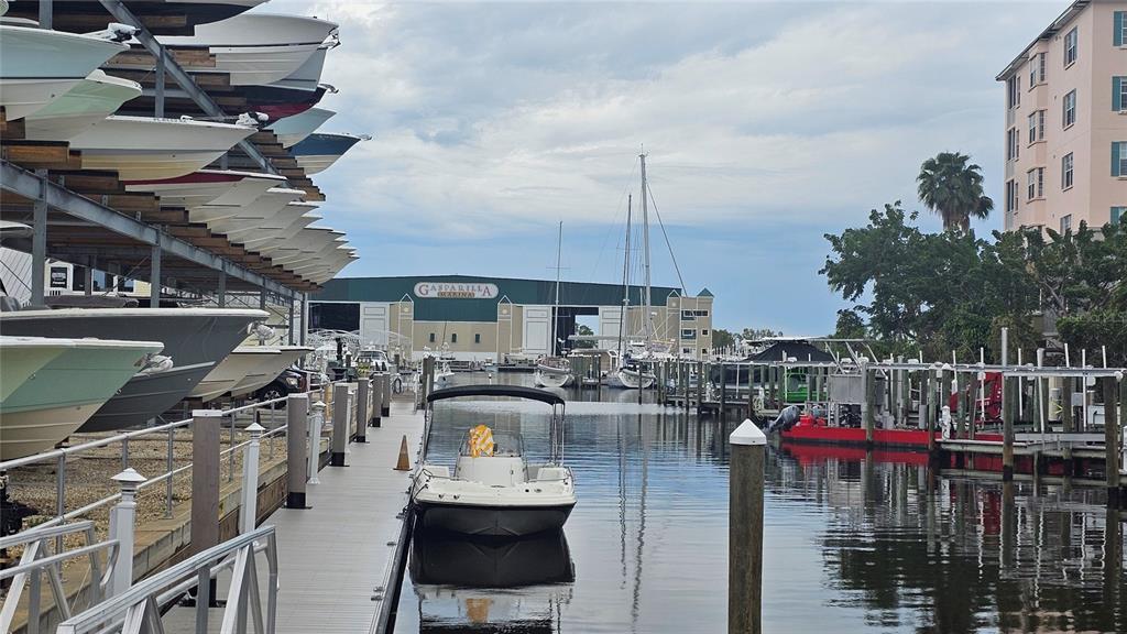 A marina features a boat storage rack, a floating dock, and several boats in water — 5431 JOSLYN TERRACE, PORT CHARLOTTE, FL