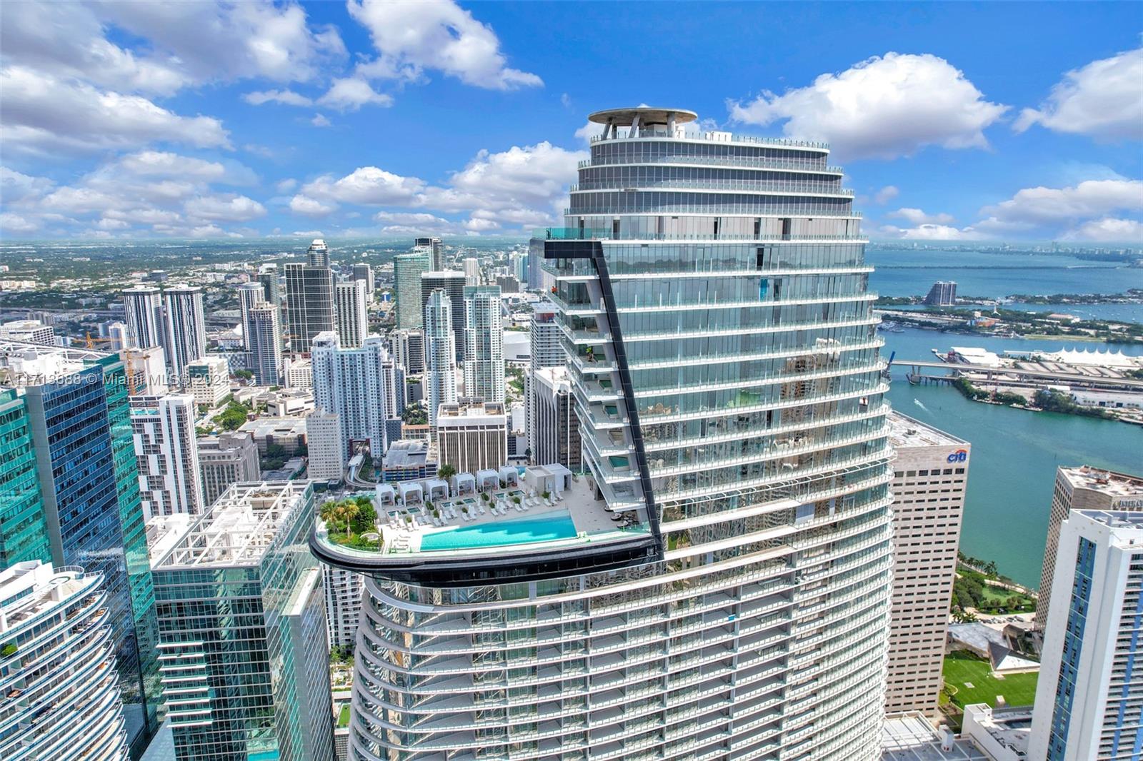 An aerial view of a modern skyscraper featuring a prominent cantilevered swimming pool deck — 300 Biscayne Blvd Way # 4303, Miami FL 33131, MIAMI, FL