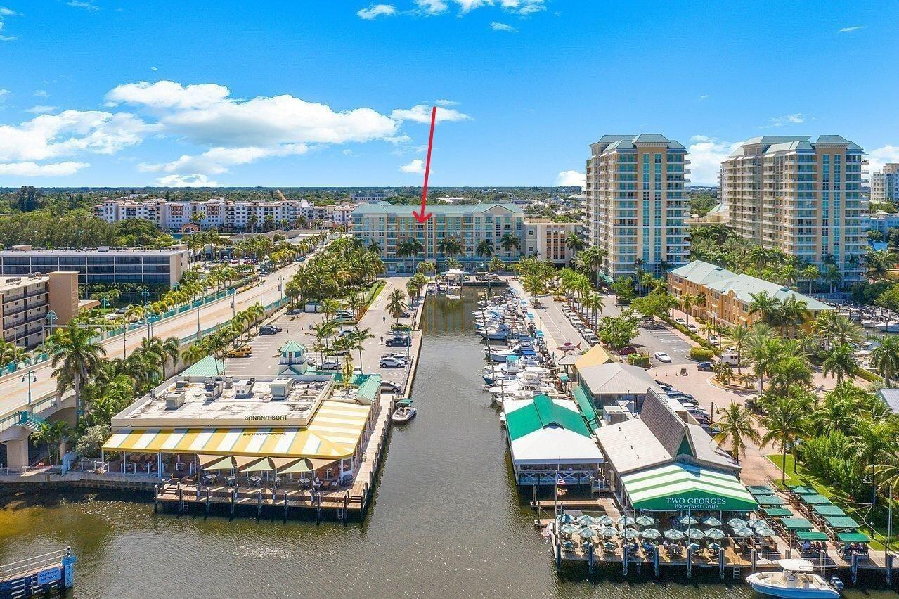 An aerial view shows a waterfront marina with restaurants and a multi-story residential building — 100 NE 6th Street # 605, Boynton Beach FL 33435, BOYNTON BEACH, FL