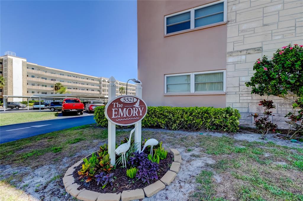 A sign for The Emory stands in a landscaped garden in front of a building — 5521 80TH STREET N UNIT 315, ST PETERSBURG, FL