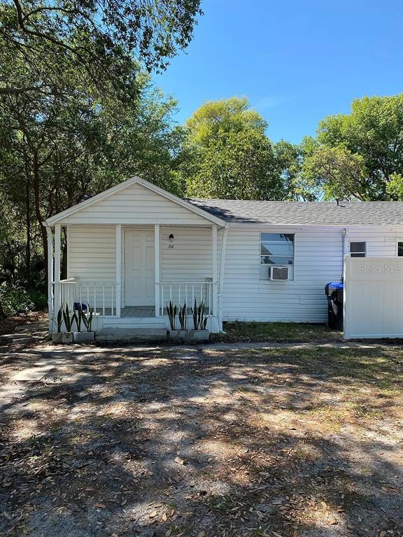 A white, single-story house with a front porch and a small yard — 58 MILEHAM DRIVE, ORLANDO, FL