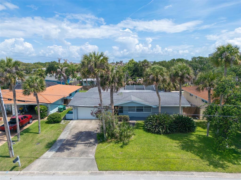 An aerial view of a single-story house with a gray roof and palm trees — 124 JUNE DRIVE, COCOA BEACH, FL