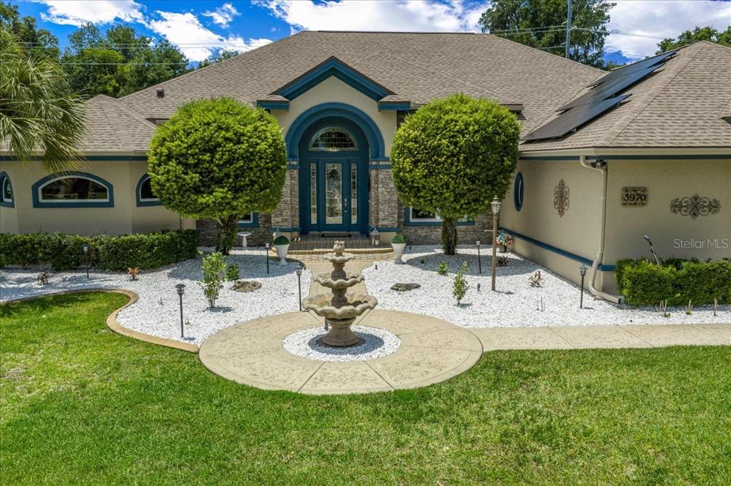A single-story house with a concrete driveway, a large front lawn, and a palm tree — 3970 SE 39TH CIRCLE, OCALA, FL