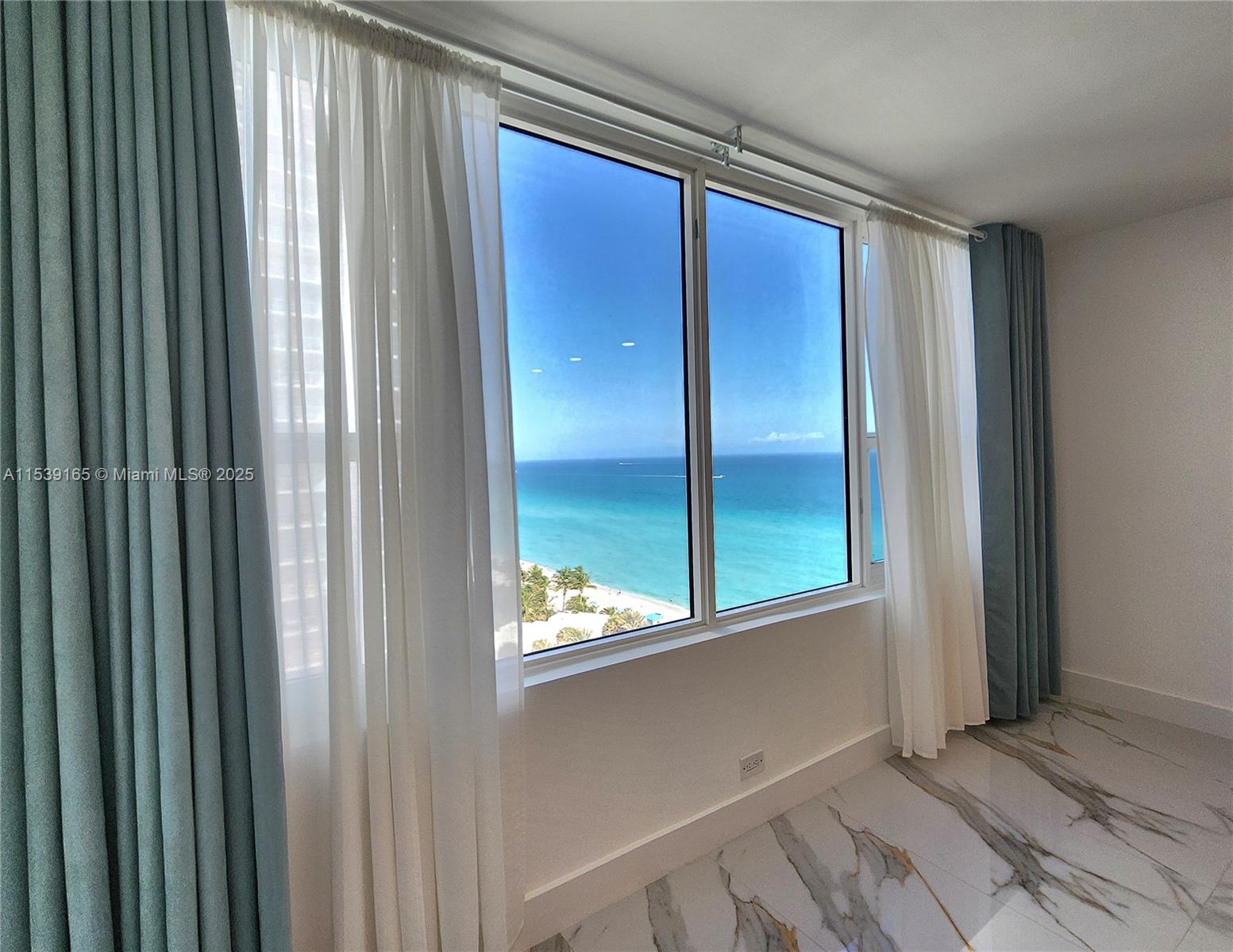 A room with marble floors and floor-to-ceiling windows overlooking the ocean and beach — 3505 S Ocean Dr # 1509, Hollywood FL 33019, HOLLYWOOD, FL