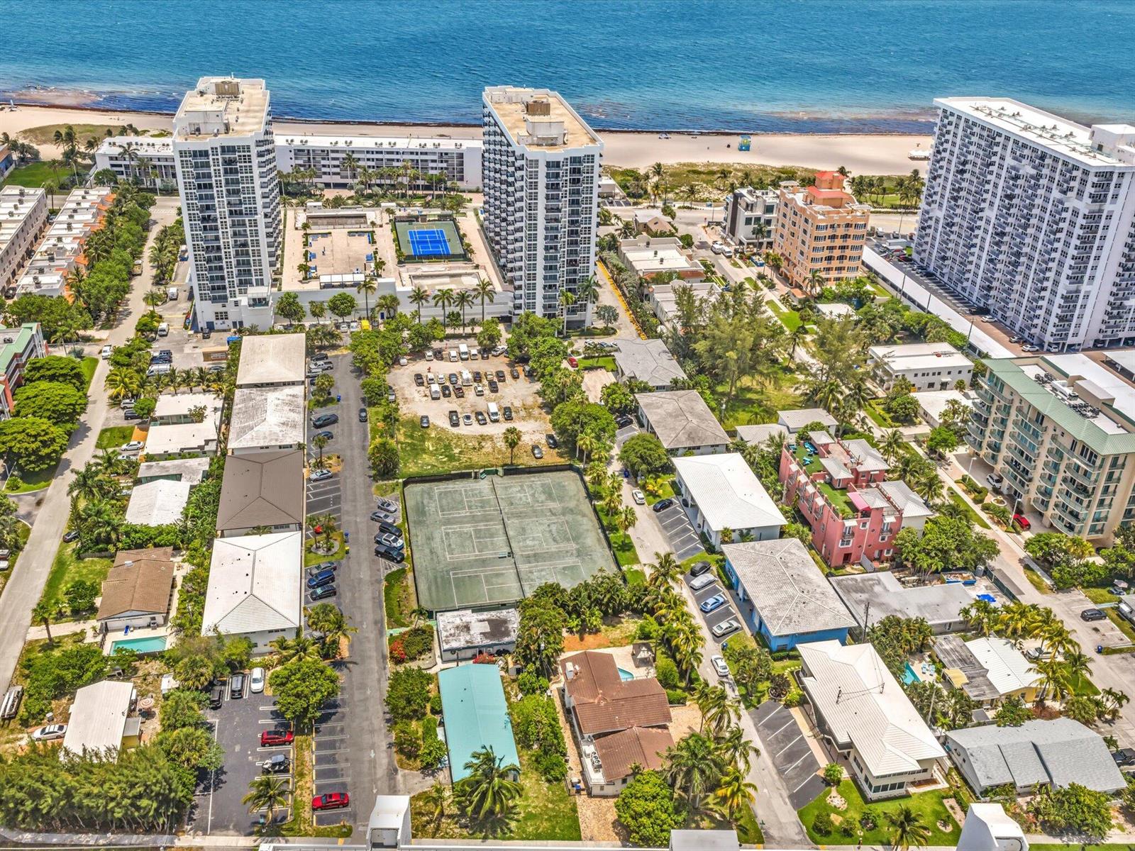 An aerial view shows residential buildings, tennis courts, a parking lot, and a beach — 524 N Riverside Drive, Pompano Beach FL 33062, POMPANO BEACH, FL