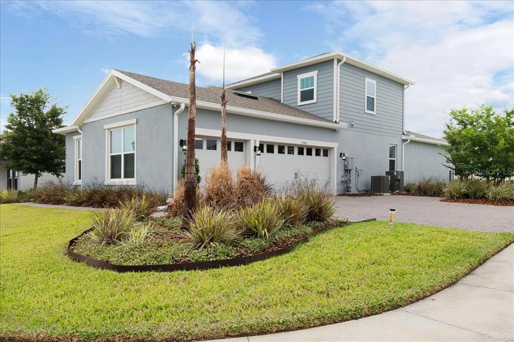 A blue, single-story suburban house features a front lawn, a walkway, and white-trimmed windows — 15363 WILLOW RIDGE DRIVE, MONTVERDE, FL