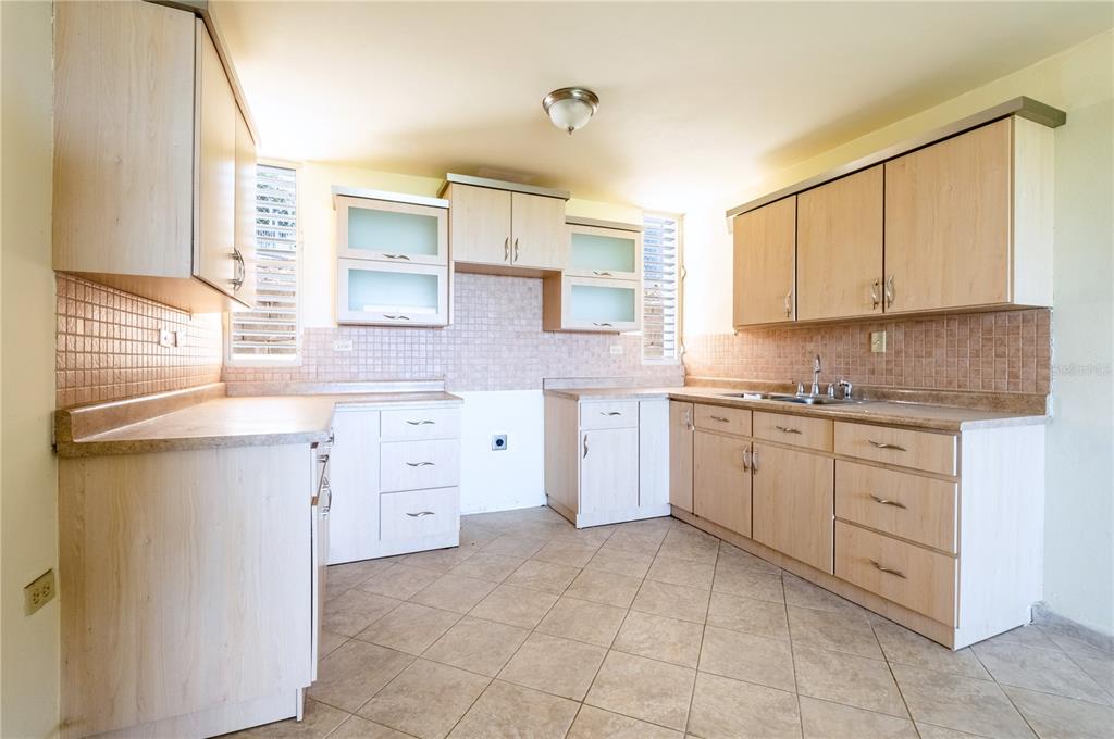 A kitchen with light wood cabinets, tiled countertops, and beige floor tiles — 000 CAMINO LOS VÉLEZ, CABO ROJO, PR