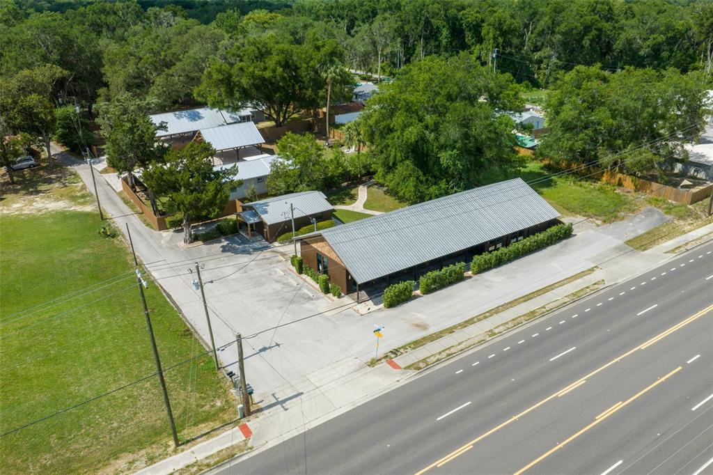 An aerial view shows a commercial building with a metal roof and adjacent parking lot — 5830 W GULF TO LAKE HIGHWAY, CRYSTAL RIVER, FL