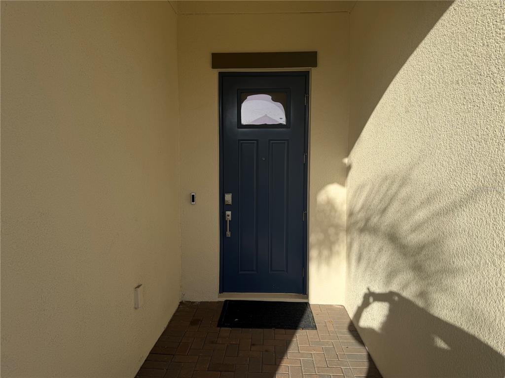 A dark blue front door with a small window is set in a recessed entryway — 17165 SCUBA CREST STREET, WIMAUMA, FL