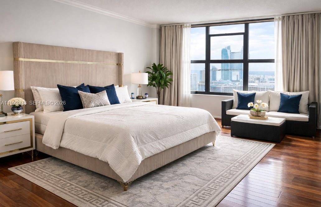 A bedroom features a large upholstered bed, a seating area, and floor-to-ceiling city views — 2500 Parkview Dr # 2206, Hallandale Beach FL 33009, HALLANDALE BEACH, FL