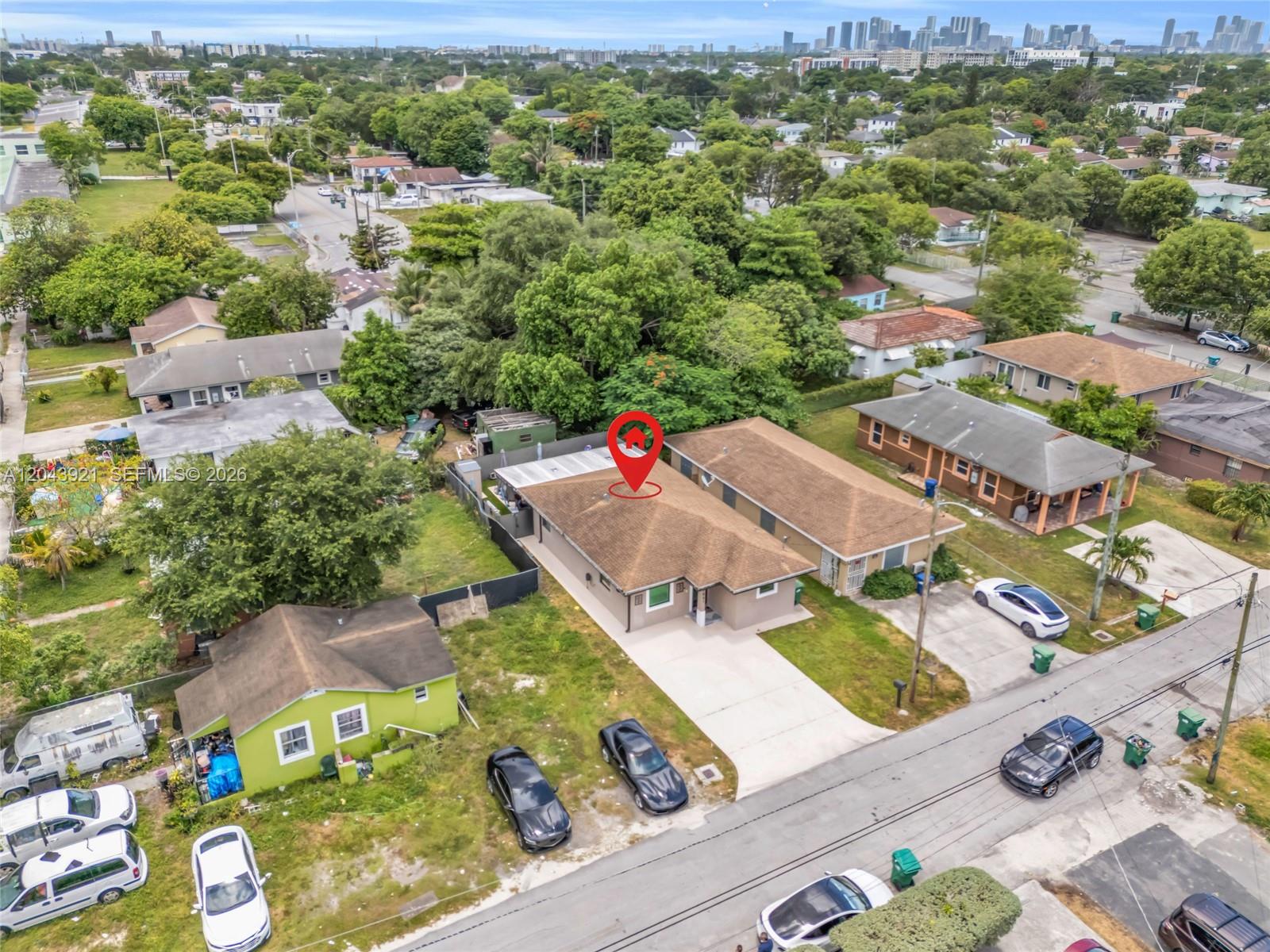 An aerial view shows a residential street with several houses and a marked property — 7031 NW 20th Ave, Miami FL 33147, MIAMI, FL