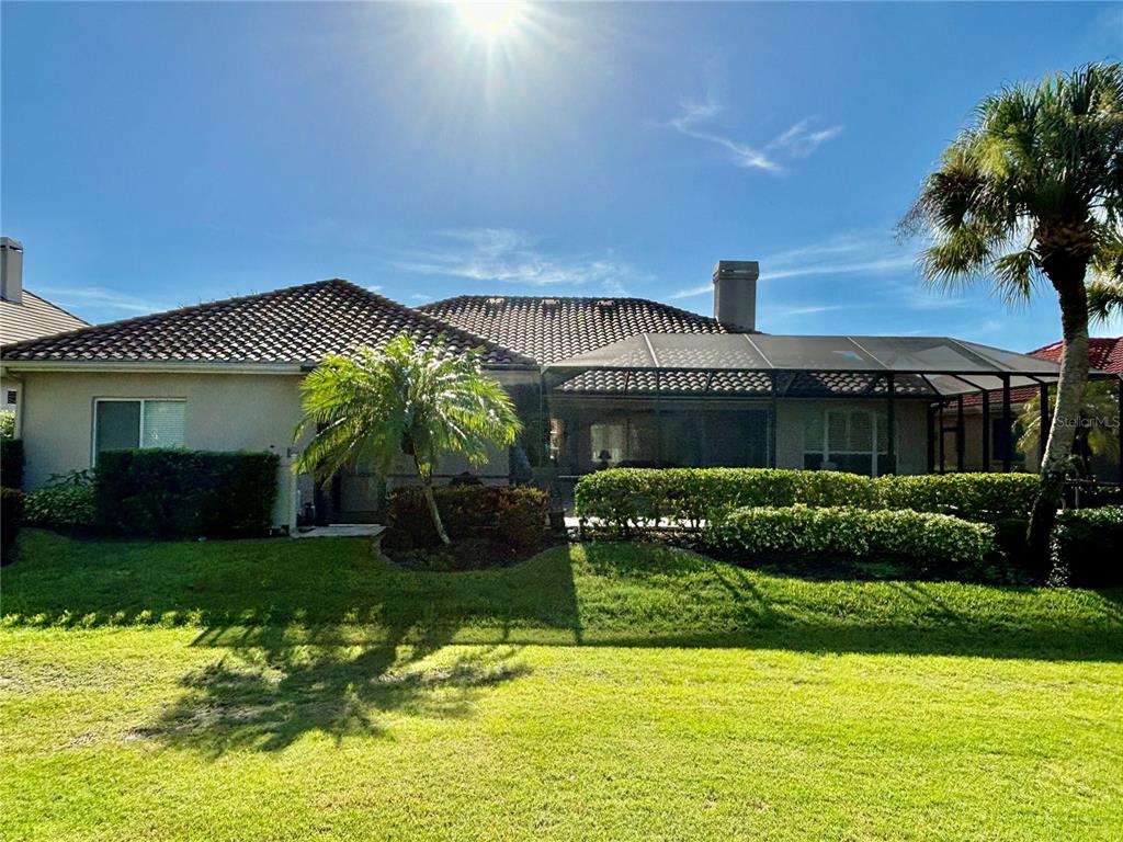 A living room features a coffered ceiling, a fireplace with built-in niches, and hardwood flooring — 403 LANSBROOK DRIVE, VENICE, FL