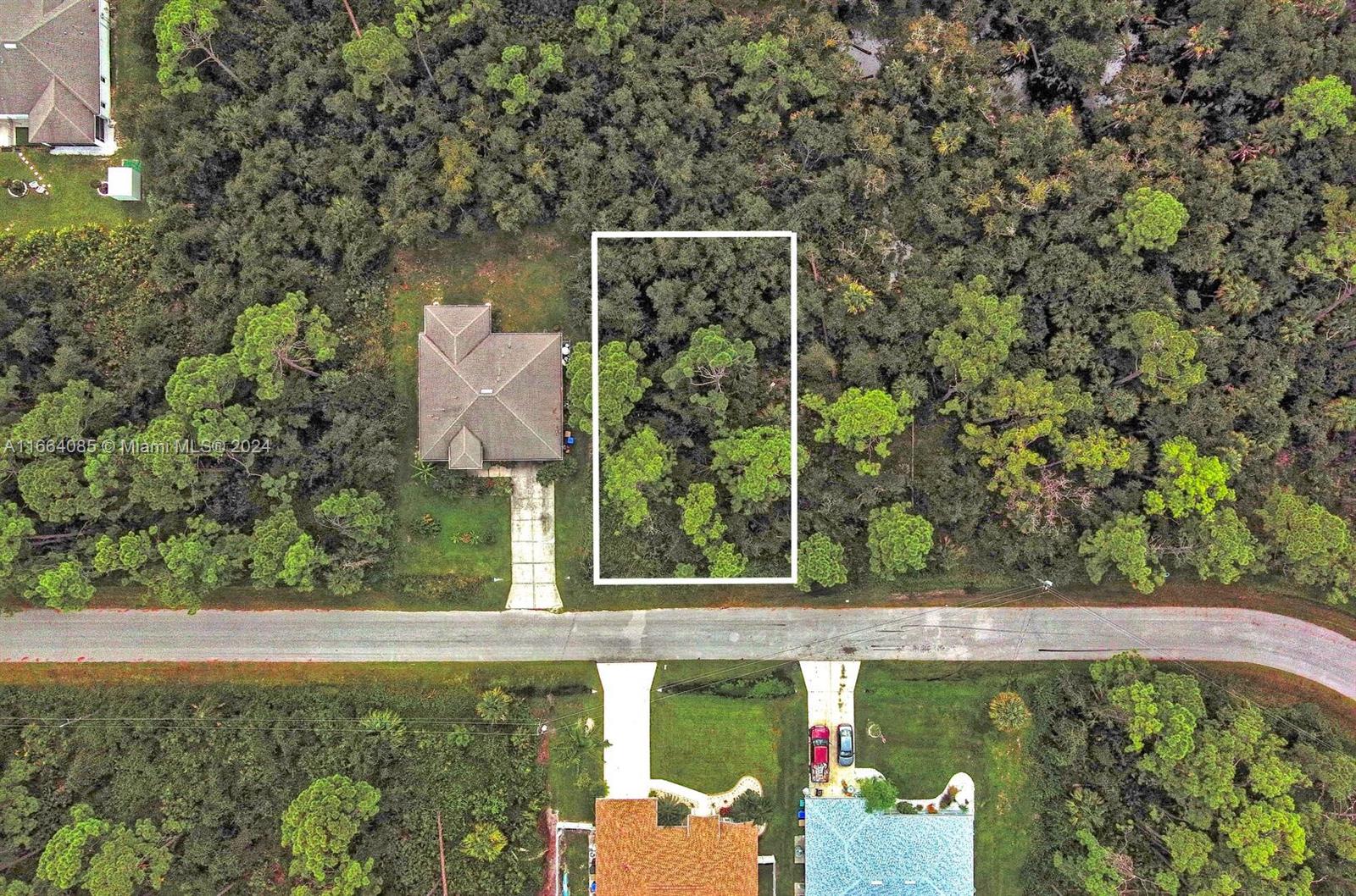 An aerial view shows a rectangular vacant lot outlined in white next to a house — #1 Shaffer Ave, North Port FL 34291, NORTH PORT, FL