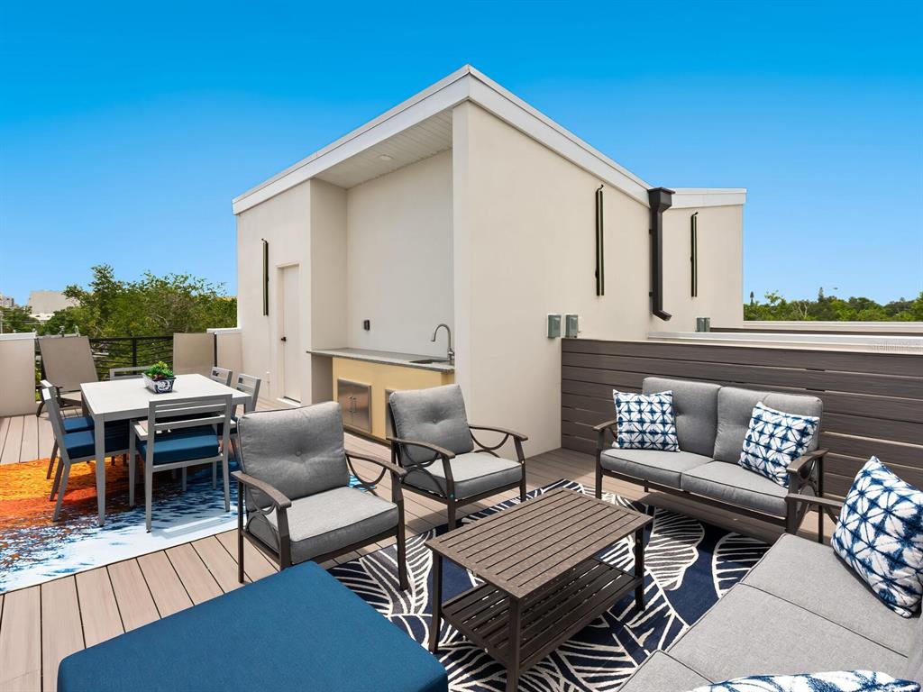 A rooftop terrace features a dining set, lounge seating, and an outdoor kitchen area — 152 AUDUBON PLACE, SARASOTA, FL