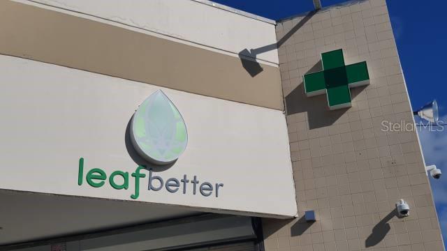The exterior of a commercial building features a green cross sign and a leaf logo — State Road PR-3 KM 28.0, RIO GRANDE, PR