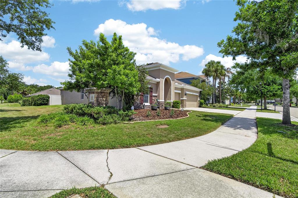 A single-story house with a tan stucco exterior and a stone-accented entrance — 11321 SCRIBNER STATION LANE, LITHIA, FL
