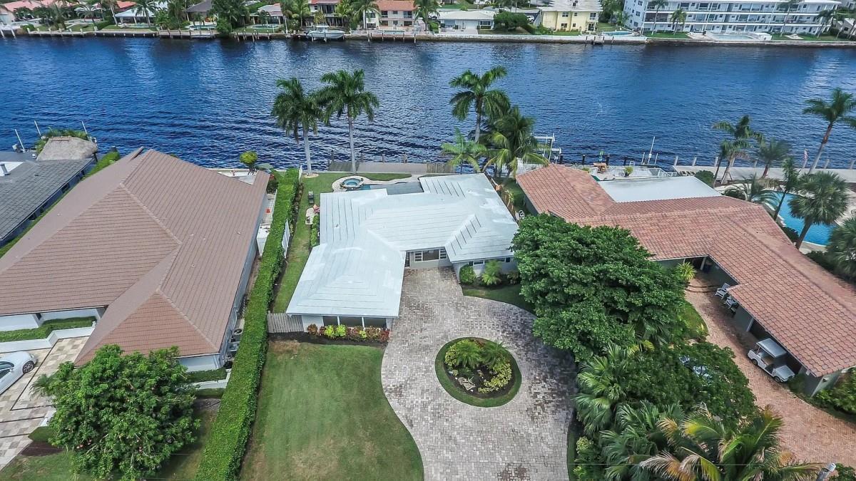 An aerial view of a waterfront house with a paved circular driveway and palm trees — 412 SE 28th Avenue, Pompano Beach FL 33062, POMPANO BEACH, FL