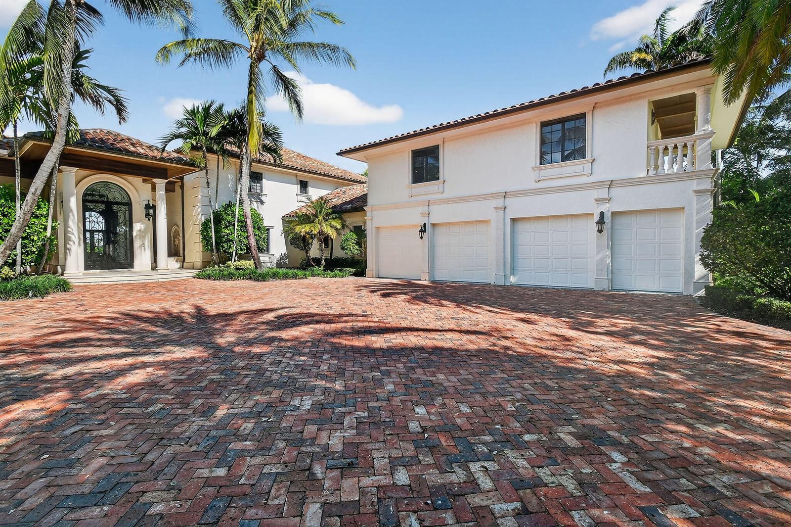 A large white house with a four-car garage and a red brick driveway — 107 Schooner Lane, Jupiter FL 33477, JUPITER, FL