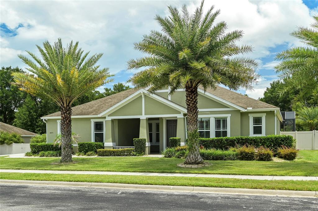 A single-story house with light green siding and two large palm trees in the front yard — 4473 BERRY OAK DRIVE, APOPKA, FL