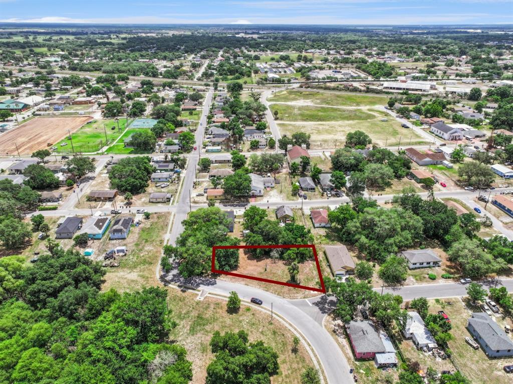 An aerial view shows a vacant, tree-lined residential lot outlined in red — 0 LAKESHORE BOULEVARD, HAINES CITY, FL