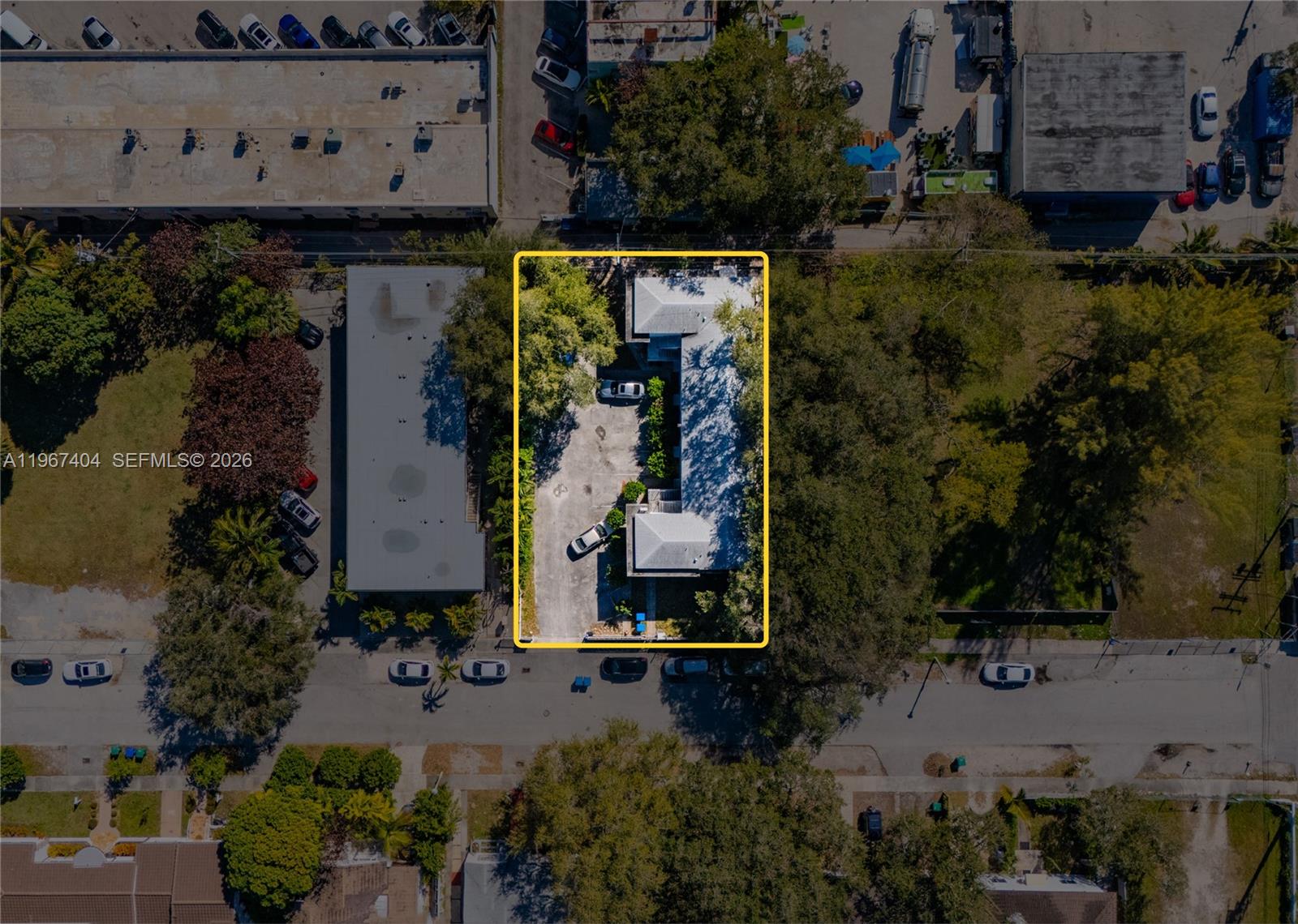 An aerial view shows a rectangular property with a building, parking area, and surrounding trees — 648 NE 80th St, Miami FL 33138, MIAMI, FL