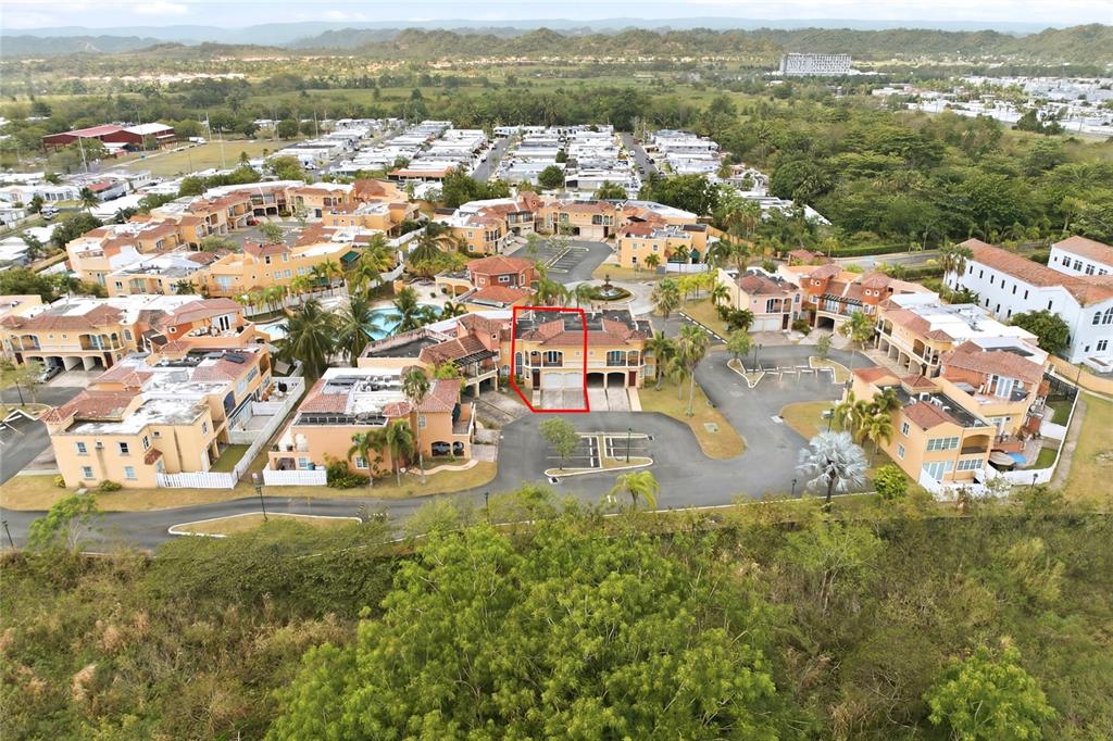 An aerial view shows a residential complex with a red-outlined townhouse in the center — E-2 BRIGHTON COUNTRY CLUB, DORADO, PR